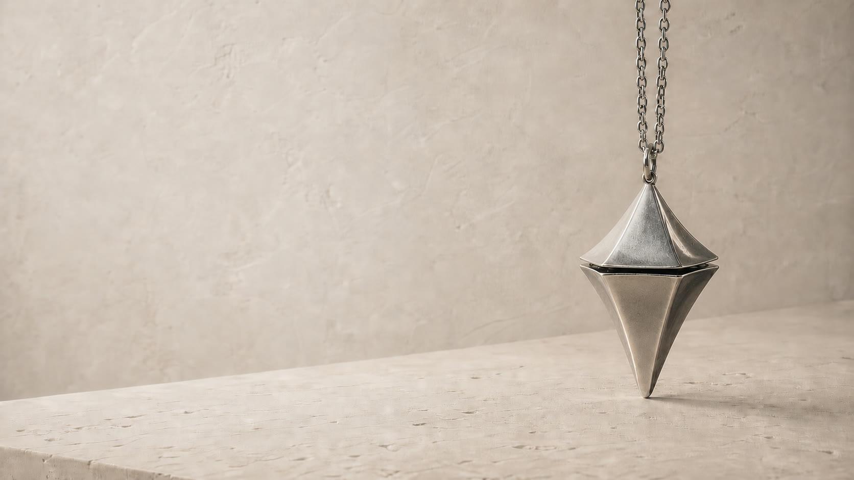 Concept visualization of the geometry-correct titanium Glimmer pendant styled as restrained jewelry